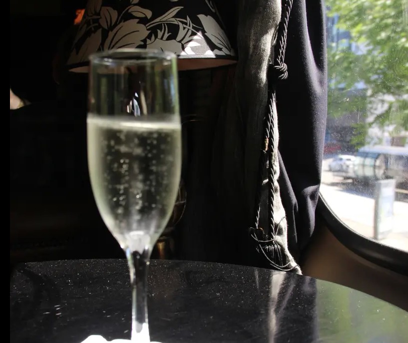Taça de espumante welcome drink na janela da Litorina de Luxo Trem de Morretes.